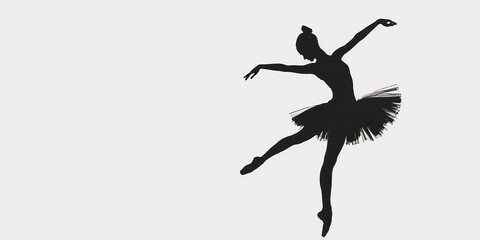 Elegant dark silhouette of a ballerina on pointe dancing gracefully against a stark white background