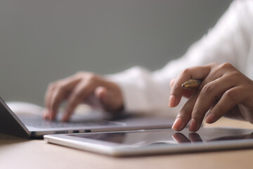 Business woman working on laptop computer with digital tablet on office table. searching the information, freelance lifestyle. Female freelancer busy working on laptop, surfing the internet,