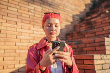 Fototapeta premium Traveler girl using mobile phone on street in city Fashion gen z asian woman .Technology connection outdoor communication generation z modern lifestyle