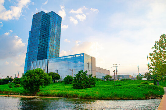 Sustainable glass office building with trees for reducing carbon dioxide. Eco-friendly building in modern city.