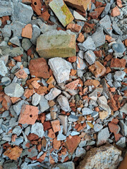 Pile of broken red bricks and fragments of concrete from destroyed building