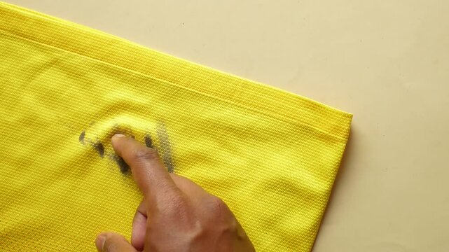  dirty mud stain on a yellow color cloth 