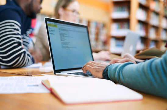 Education, university and hands of student on laptop in library for learning, knowledge and research. School, college and person with computer, books and friends for project, studying or assignment