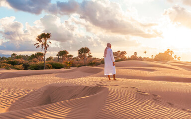 Yellow sunset in the desert and sun rays spreading. Beautiful dramatic clouds on gold sky. Golden...