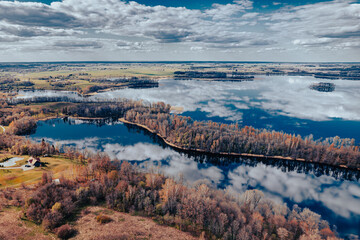 aerial view of a forest and big lake in Europe in autumn