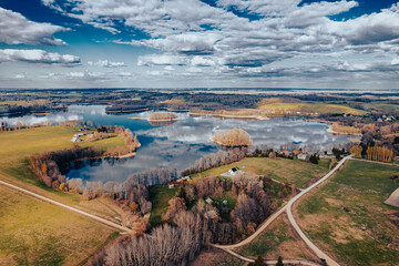 aerial view of a forest and big lake in Europe in autumn