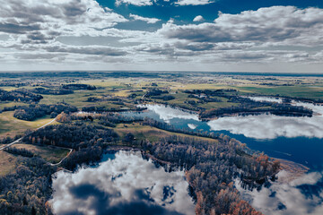 aerial view of a forest and big lake in Europe in autumn