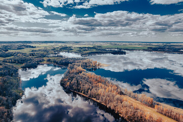 aerial view of a forest and big lake in Europe in autumn