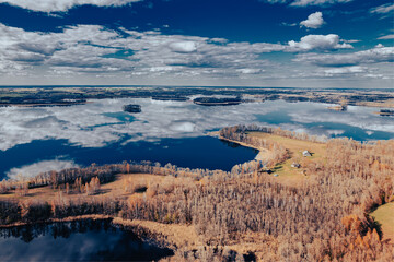 aerial view of a forest and big lake in Europe in autumn