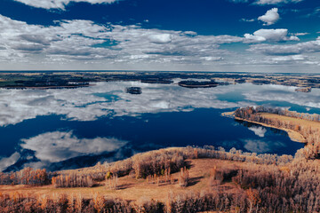 aerial view of a forest and big lake in Europe in autumn
