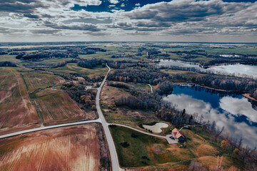 aerial view of road in the countryside and big lake in Europe in autumn aerial photo