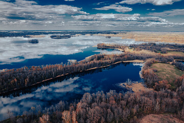 aerial view of a forest and big lake in Europe in autumn