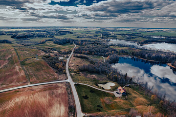 aerial view of road in the countryside and big lake in Europe in autumn aerial photo