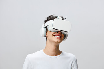 Virtual reality experience, smiling young man wearing VR headset and headphones, enjoying immersive technology, modern and minimalist background, focused on digital adventures