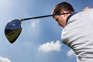 Sports, golf course and man with swinging for playing, training and practice for tournament game. Country club, male person or golfer with skills for championship match, coordination and kit outdoor