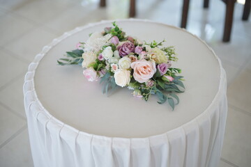 Beautiful flowers arrangement
on a white round table. Decoration for holiday, birthday, Wedding, Mother's Day, Valentine's day, Women's Day