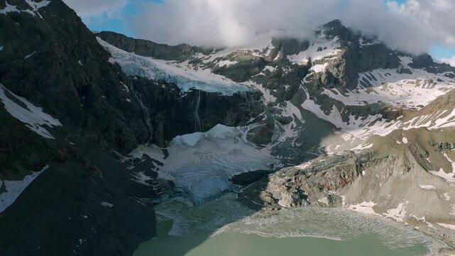 Clouds Over Rugged Mountains At Fellaria Glacier In Valmalenco, Central Rhaetian Alps, Italy. Aerial Drone Shot