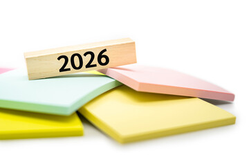 2026 text wooden block on colorful sticky note. 2026 new year idea concept.