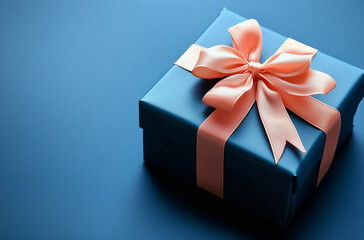 Obraz premium Cobalt Gift Box with Peach Bow on Cobalt Background - Chic and Sophisticated Packaging