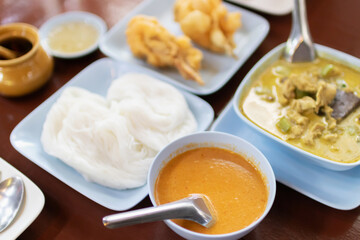 Kanom jeen nam ya ; Rice noodles in fish curry sauce. Traditional Thai cuisine, rice vermicelli served with vegetables on Thai style set