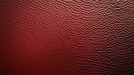 Fototapeta premium A close up of a red leather surface with a pattern. The texture of the leather is very fine and the color is deep red