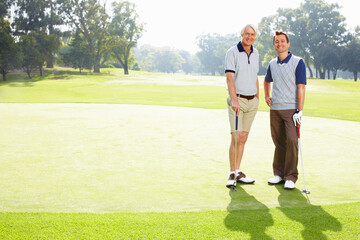 Obraz premium Portrait, golf course and father with son, health and grass field with fitness, recreation and sports. Face, family or people with wellness, nature or happy men with training, routine or hobby