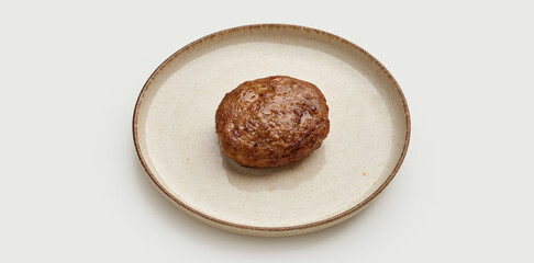 A juicy and flavorful beef patty is presented on a beige plate against a clean white background.