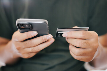 A man holding smartphone and credit card for online electronic transaction payment