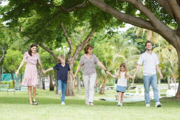 Fototapeta premium Caucasian family parent and their children picnic at the park in morning.