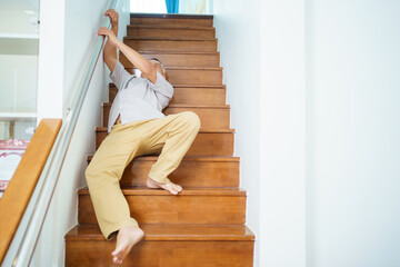 Senior male adult has an accident while walking on staircase.