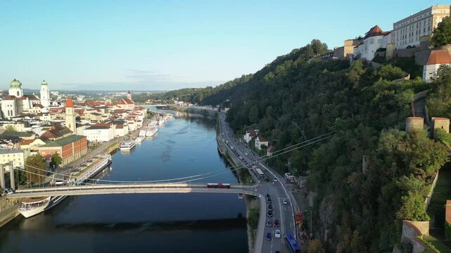 Aerial turn over river Danube, castle Vesta Oberhaus, centra city with churches, cathedral, city hall and river Inn in Passau, Bavaria, Germany