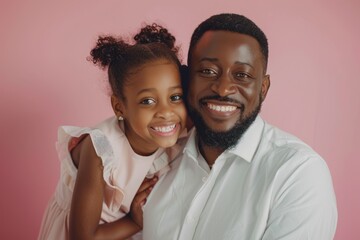 Obraz premium Portrait of happy african american father and daughter on pink background