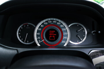 A battery charging system malfunction is displayed on the vehicle dashboard screen , Car repair concept