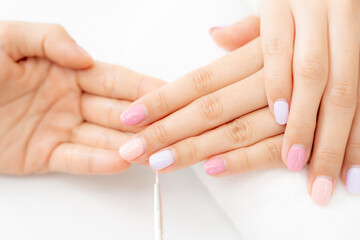 Fototapeta premium Woman receive care service by professional Beautician Manicure at spa centre. Nail beauty salon use nail file for Glazing treatment. manicurist make nail customer to beautiful. body care spa treatment