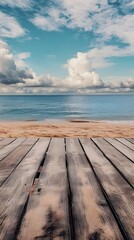 Fototapeta premium Wooden Planks Facing a Blue Ocean and Sandy Beach with a Cloudy Sky