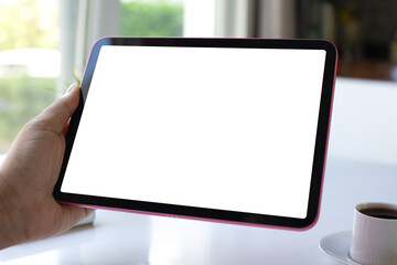 male hand holding computer tablet with isolated screen in cafe