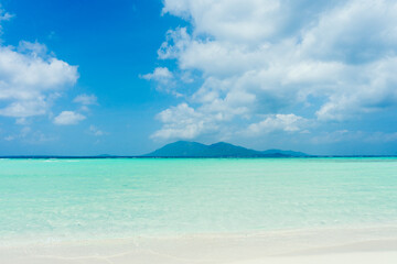 Landscape beach sand and sea water blue with blue sky background. Summer vacation and summer...