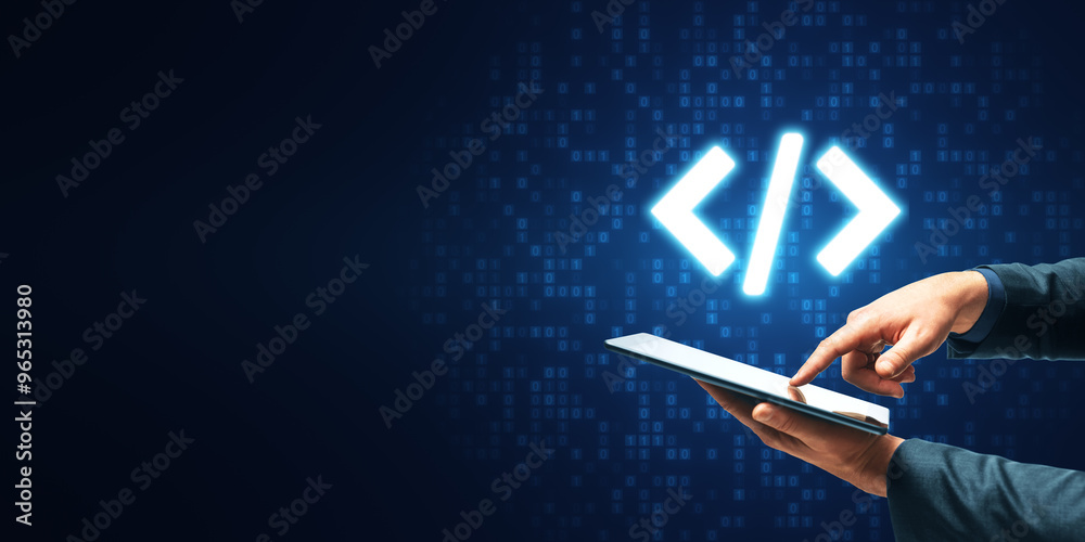 Leinwandbilder Close up of businessman hand pointing at tablet with glowing programming code on blue binary coding background with mock up place. Program and software development concept.