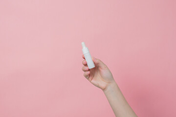 Hand holds serum glass white bottle (essential oil) with pipette. Luxury product cosmetic advertising