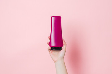 Cosmetic unbranded bottle for shampoo, mask, lotion with pink background. Concept of beauty. Product cosmetic advertising