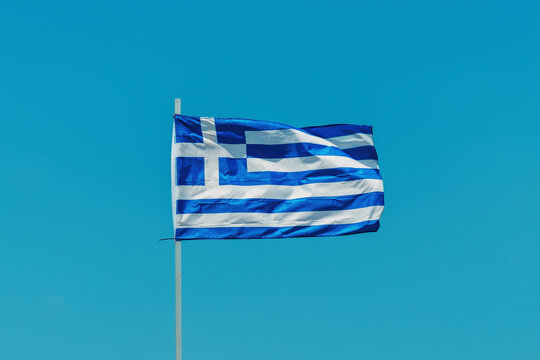 Greek flag against lear blue sky - Powered by Adobe