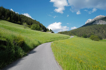 Local road at Santa Maddalena Landscape at Val di Funes, land of the pale mountains and valley in the Dolomites, UNESCO World Heritage- South Tyrol, Italy