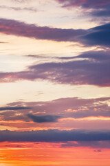 Twilight sky with light pastel orange color effect. Colorful sunset soft clouds. vertical