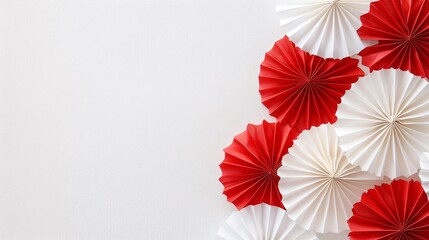 Obraz premium Delicate red and white paper fans against a minimalist background, creating a charming, vintage atmosphere with ample blank space for Canada Day text