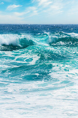 Waves on the beach in windy day. Santorini island, Greece.