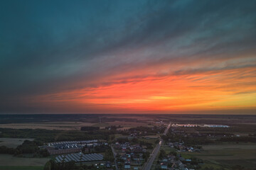 Summer evening sunset with rain clouds over small town