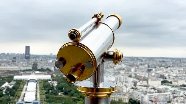 Close-Up of Telescope on Eiffel Tower, view of the trocadero and other parisian landmarks on a cloudy parisian day from the eiffel tower.
