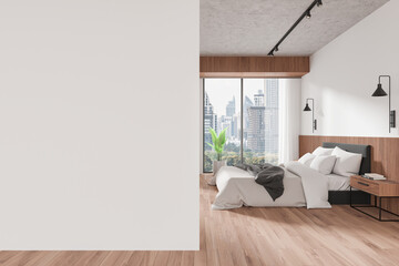 Stylish hotel bedroom interior with bed and panoramic window. Mockup wall