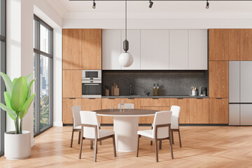 Stylish home kitchen interior with cabinet and eating table, panoramic window