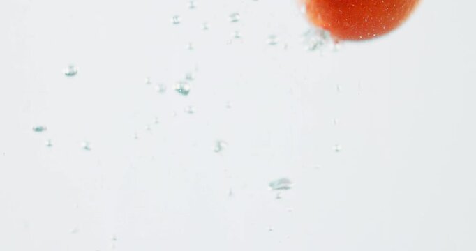 Fruit, orange and water with vitamin c for nutrition, fresh produce or hydration in studio on a white background. Closeup of juicy, natural organic food or citric acid in wet splash for healthy diet